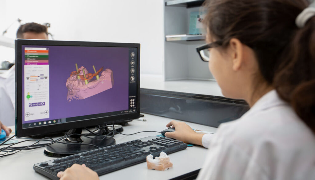 woman at dental lab verifying scans sent to dental lab