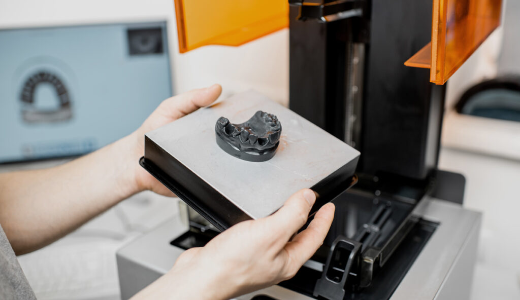 dental technician showing 3d printed scan of teeth