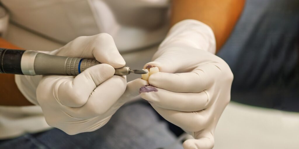 Dental technician working on a restoration and digital dental design